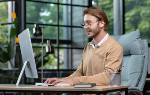 a-young-male-programmer-freelancer-sits-in-the-of-2023-02-11-05-25-15-utc