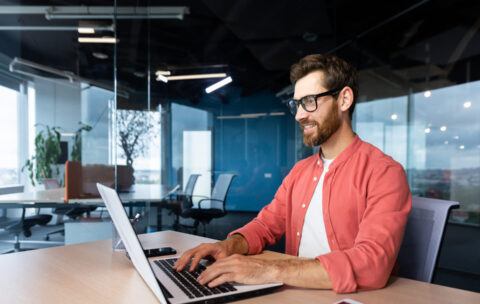successful-smiling-man-working-inside-office-with-2023-01-30-03-25-12-utc