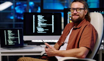young-smiling-male-it-engineer-in-eyeglasses-using-2023-04-04-18-49-50-utc