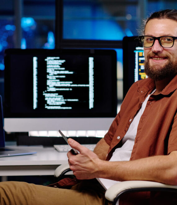 young-smiling-male-it-engineer-in-eyeglasses-using-2023-04-04-18-49-50-utc